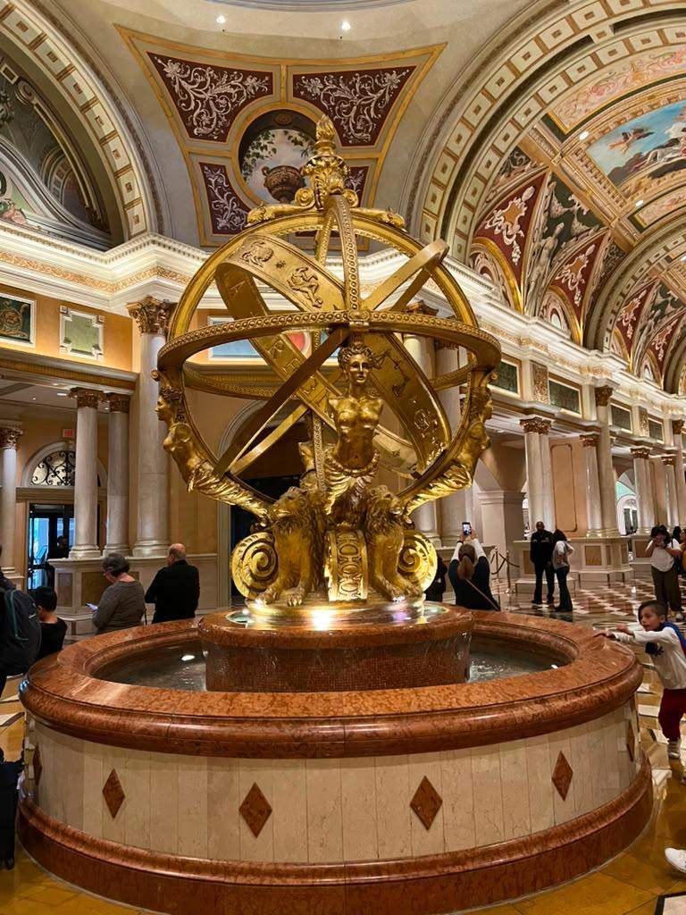 Ornate golden armillary sphere fountain inside The Venetian, Las Vegas